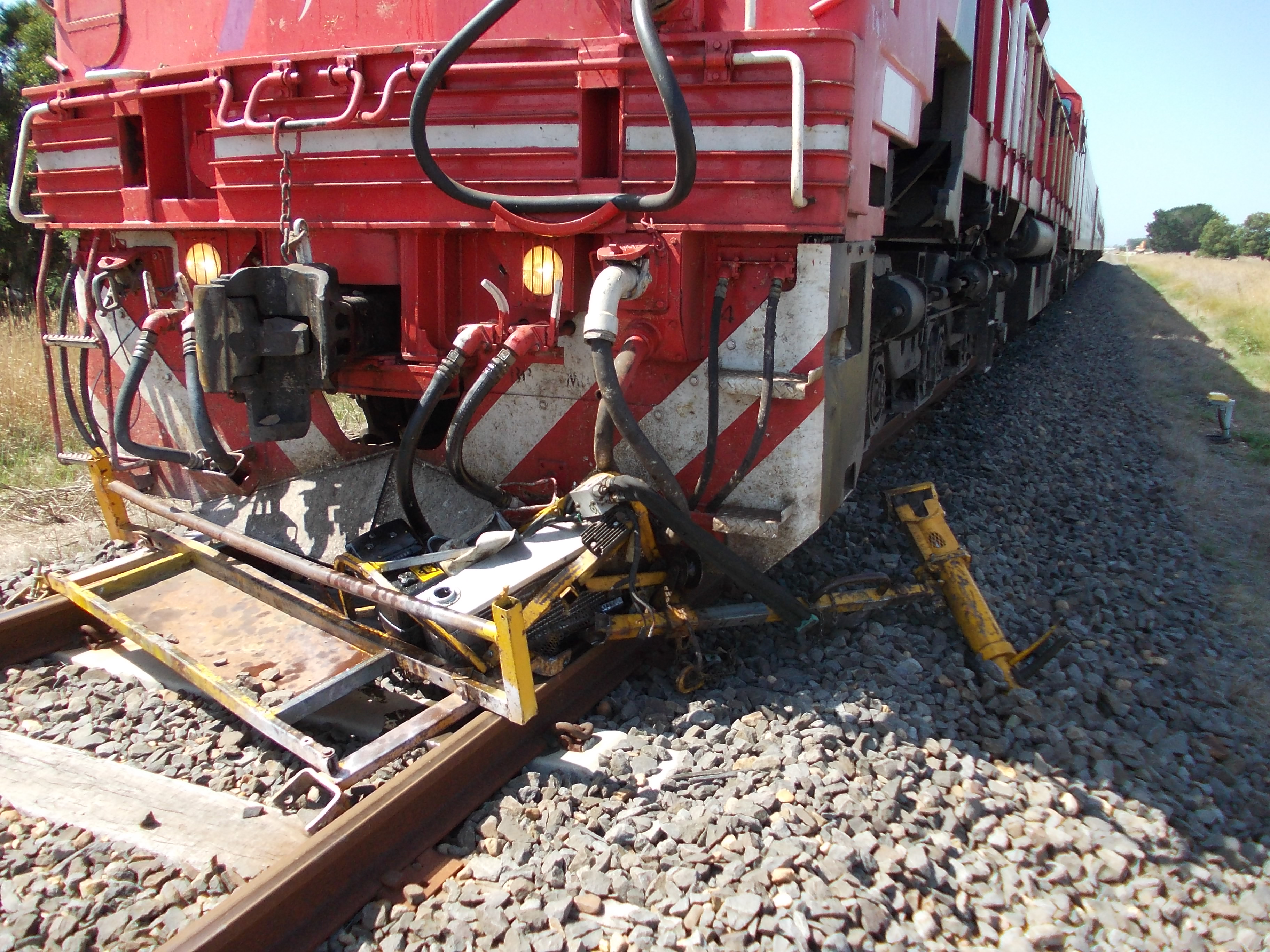 Figure 2: Destroyed dog spike puller under the cow catcher of locomotive N452
